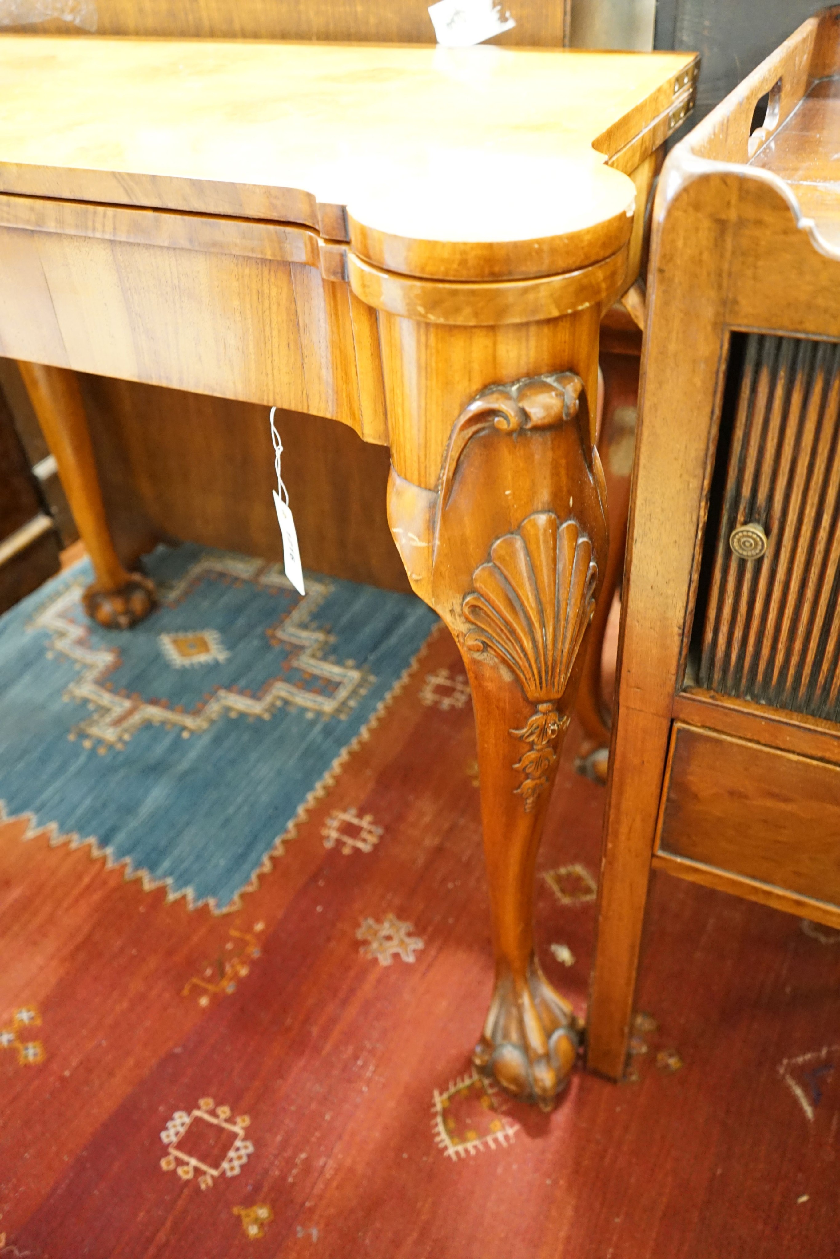 A Queen Anne revival burr walnut card table, with a red leather interior, length 86cm, depth 43cm, height 74cm